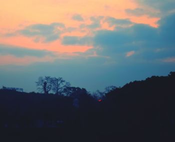 Silhouette landscape against sky at sunset