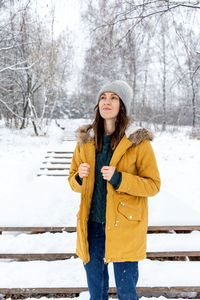 Full length of woman standing in snow