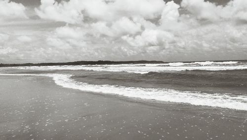 Scenic view of sea against cloudy sky