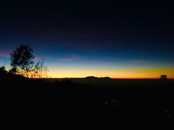 Scenic view of silhouette landscape against sky at sunset