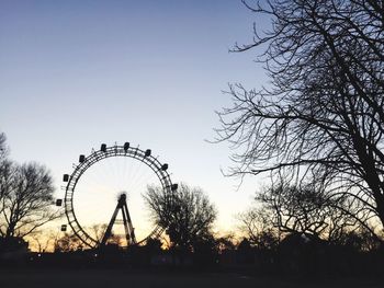 Silhouette ferris wheel against sky during sunset