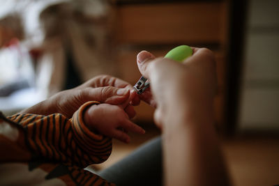 Cropped image of woman hand holding cigarette