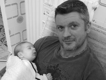 Portrait of father with baby at home