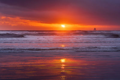 Scenic view of sea against romantic sky at sunset