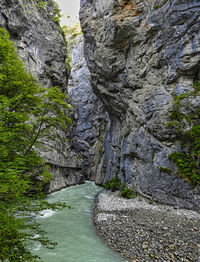 Scenic view of canal amidst rocky mountains