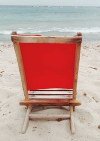 Empty chair on shore at beach
