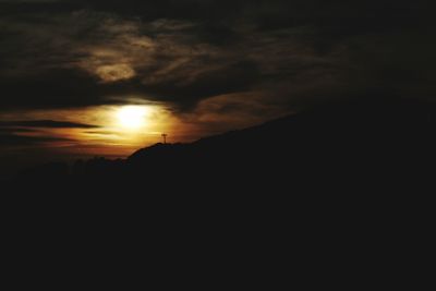 Silhouette of landscape against sunset sky