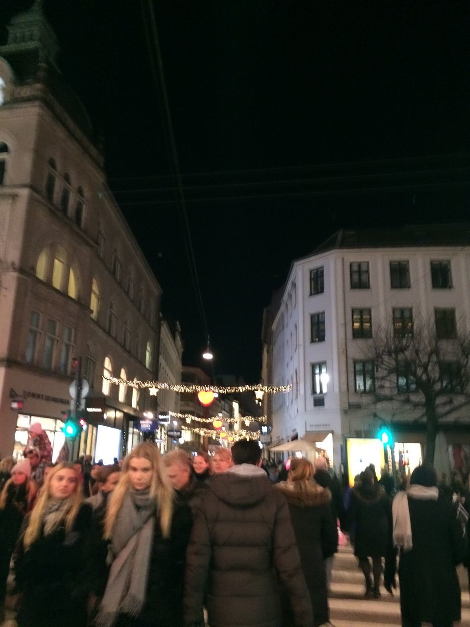 PEOPLE AT ILLUMINATED CHRISTMAS TREE AT NIGHT