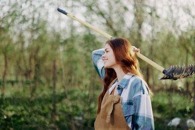 Smiling woman holding farmer rack