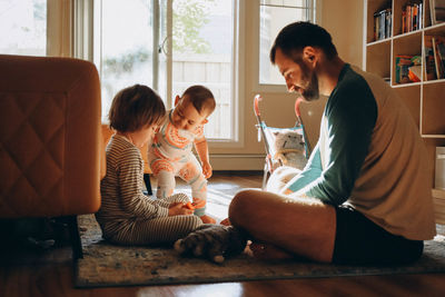Family sitting on sofa at home