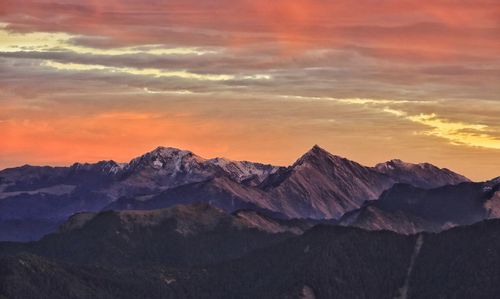 Scenic view of snowcapped mountains against sky during sunset