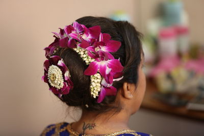 Rear view of woman with pink flower