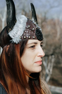 Close-up portrait of woman wearing hat