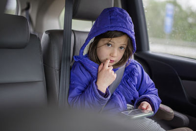 Portrait of woman sitting in car