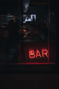 Text on glass window at night