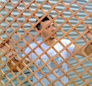 High angle portrait of man seen through glass