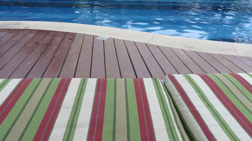 Lounge chairs against swimming pool