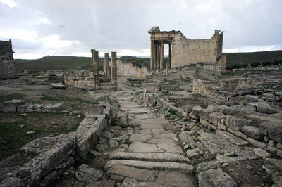 Old ruins of building against cloudy sky