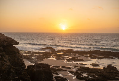 Scenic view of sea against sky during sunset