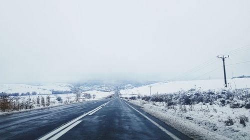 Road against clear sky during winter