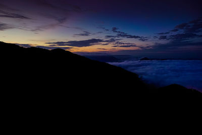 Scenic view of silhouette mountain against sky at sunset