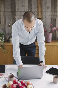 High angle view of businessman using laptop at desk in portable office truck