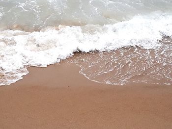 High angle view of waves rushing towards shore