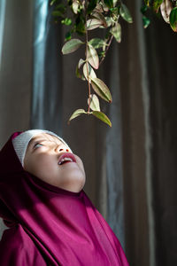 Portrait of a happy muslim toddler girl with hijab. natural light, selective focus.