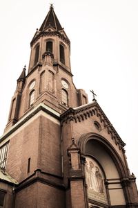 Low angle view of bell tower against sky