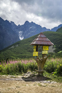 Information sign on landscape against sky