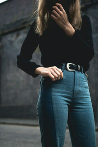 Woman using mobile phone in city