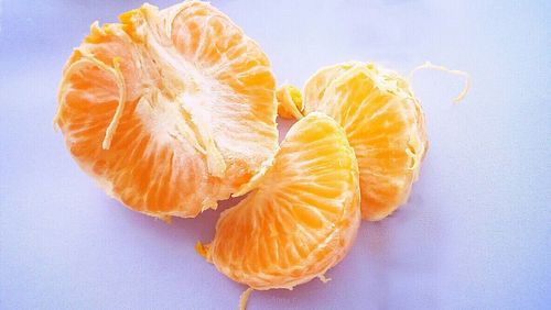 Close-up of orange over white background