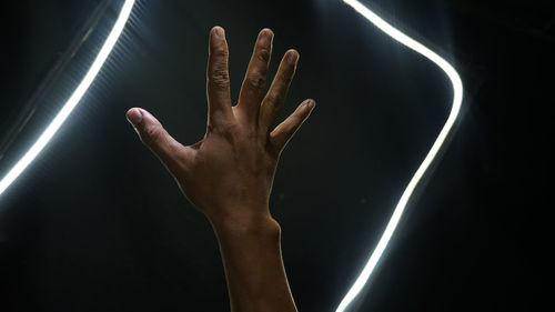 Close-up of hand against black background