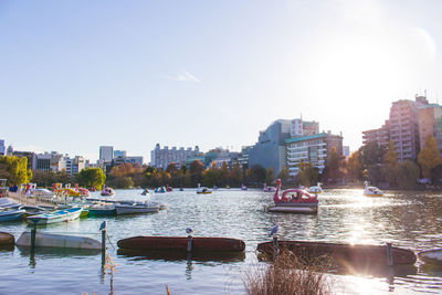 Boats in river with buildings in background