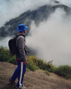 Rear view of man walking on field