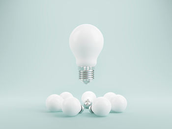 Close-up of light bulb against white background