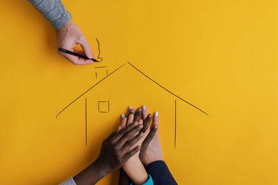 Close-up of person hand holding yellow art