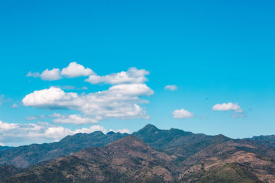 Scenic view of mountains against cloudy sky