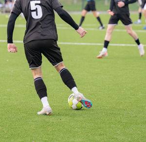 People playing soccer on field