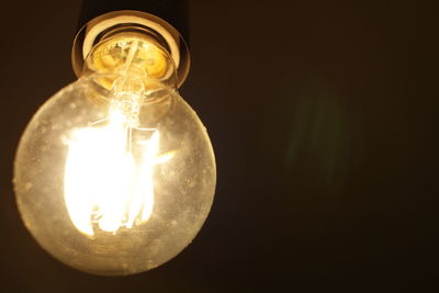 Close-up of illuminated light bulb