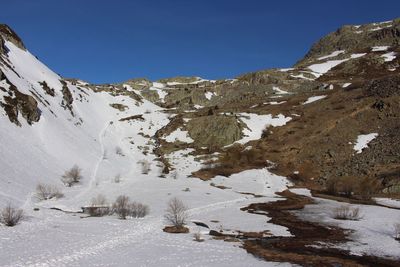 Scenic view of mountains against clear sky during winter