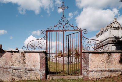 View of metal gate against sky