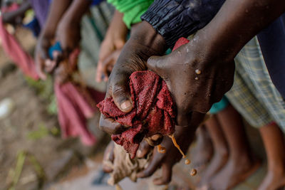 Cropped hands squeezing cloth