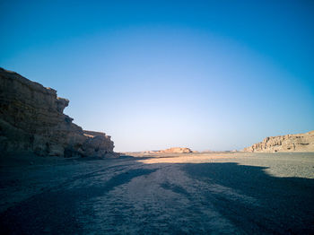 Rock formations against clear blue sky