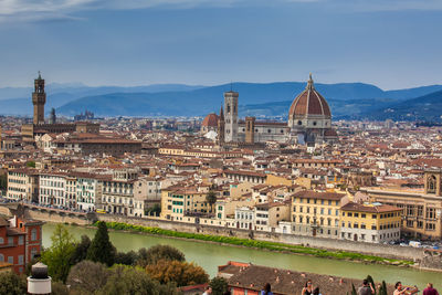 Tourists at the viewpoint of michelangelo square looking at the beautiful city of florence