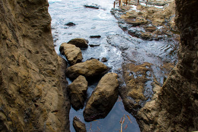 High angle view of wet rock in sea