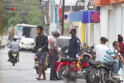 Rear view of people on street in city