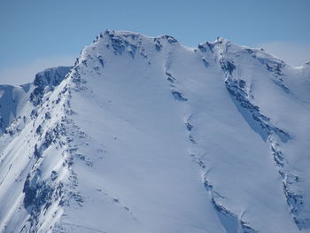 Scenic view of snowcapped mountains against clear sky