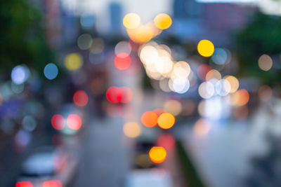 Defocused image of illuminated city street at night