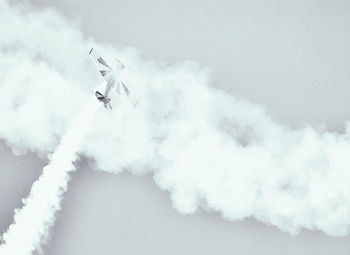 Low angle view of airshow against sky